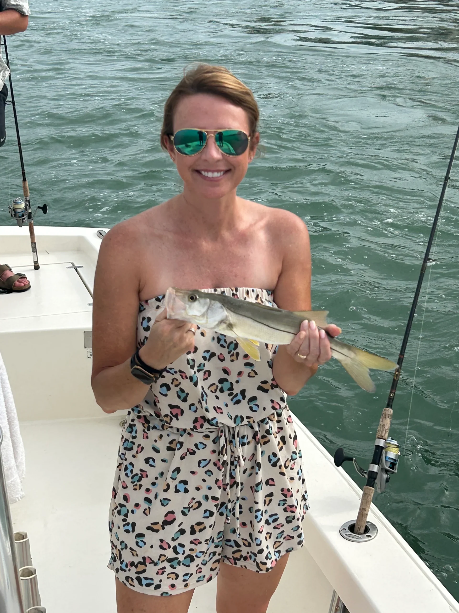 Woman holding a snook caught during an inshore fishing charter in Sarasota Bay, Florida